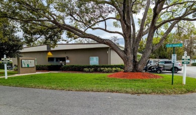 OWNER WILL CONSIDER FINANCING OPTION! Palm trees line the front on Grasslands Golf and Country Club in Florida - for sale on GolfHomes.com, golf home, golf lot