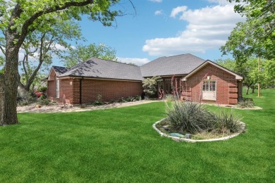 Walk out to the golf course from your large screened in back on Pecan Plantation Country Club in Texas - for sale on GolfHomes.com, golf home, golf lot