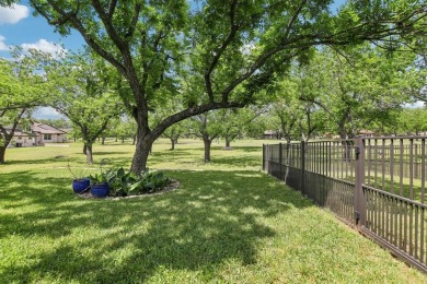 Walk out to the golf course from your large screened in back on Pecan Plantation Country Club in Texas - for sale on GolfHomes.com, golf home, golf lot