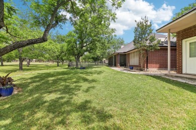 Walk out to the golf course from your large screened in back on Pecan Plantation Country Club in Texas - for sale on GolfHomes.com, golf home, golf lot