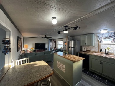 This beautifully updated 2-bedroom, 2-bathroom unfurnished home on Lake Henry Golf Club in Florida - for sale on GolfHomes.com, golf home, golf lot