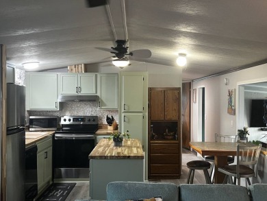 This beautifully updated 2-bedroom, 2-bathroom unfurnished home on Lake Henry Golf Club in Florida - for sale on GolfHomes.com, golf home, golf lot