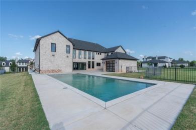 Welcome to a glorious modern residence nestled behind the gates on Oak Tree National Golf and Country Club in Oklahoma - for sale on GolfHomes.com, golf home, golf lot