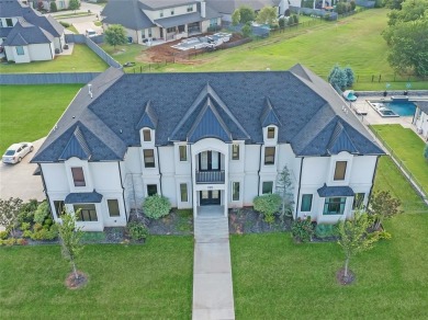 Welcome to a glorious modern residence nestled behind the gates on Oak Tree National Golf and Country Club in Oklahoma - for sale on GolfHomes.com, golf home, golf lot