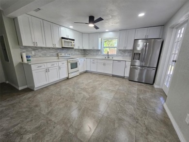 This beautifully brand new updated 3-bedroom, 2-bathroom home on Bayou Golf Club in Florida - for sale on GolfHomes.com, golf home, golf lot