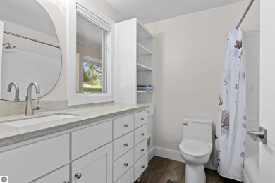Welcome to a completely updated and enchanting 4-bedroom, 4-bath on Manitou Passage Golf Club in Michigan - for sale on GolfHomes.com, golf home, golf lot