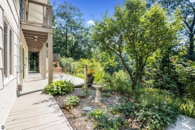 Welcome to a completely updated and enchanting 4-bedroom, 4-bath on Manitou Passage Golf Club in Michigan - for sale on GolfHomes.com, golf home, golf lot