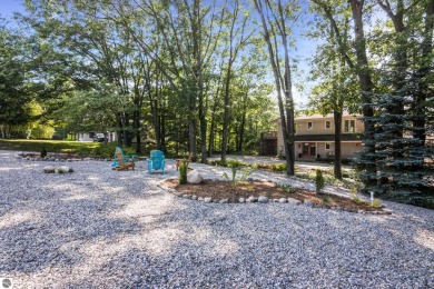 Welcome to a completely updated and enchanting 4-bedroom, 4-bath on Manitou Passage Golf Club in Michigan - for sale on GolfHomes.com, golf home, golf lot
