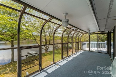 LAKEFRONT LIVING AS IT'S FINEST! Nestled in serene natural on Connestee Falls Golf Club in North Carolina - for sale on GolfHomes.com, golf home, golf lot