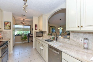 This charming home sits pretty on an oversized lot with stunning on Eagle Wood Golf Course in Florida - for sale on GolfHomes.com, golf home, golf lot
