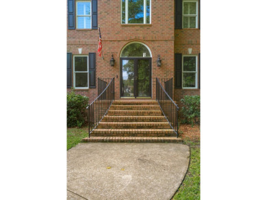 This distinguished two-story brick residence offers four on Dunes West Golf Club in South Carolina - for sale on GolfHomes.com, golf home, golf lot