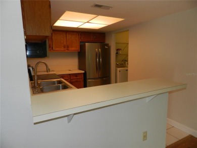Freshly painted 2 bedroom, 2 bath ground floor end unit with1 on Innisbrook Resort and Golf Club in Florida - for sale on GolfHomes.com, golf home, golf lot