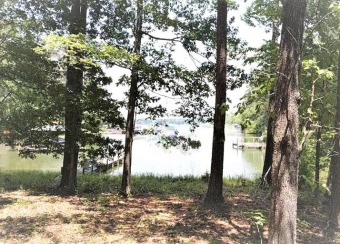 Live the Lake Life! This gently sloping waterfront lot offers for sale on GolfHomes.com