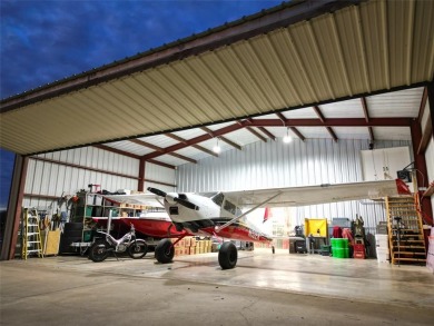 Rate takeoffs and landings from your back patio!  This lovely on Pecan Plantation Country Club in Texas - for sale on GolfHomes.com, golf home, golf lot