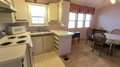 TWO BEDROOM, 1 1/2 BATHROOM MOBILE HOME IN ACTIVE 55+ COMMUNITY on River Run Golf Links in Florida - for sale on GolfHomes.com, golf home, golf lot