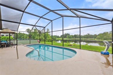 Very nice pool home that is waterfront located in in Ridgewood on Ridgewood Lakes Golf and Country Club in Florida - for sale on GolfHomes.com, golf home, golf lot