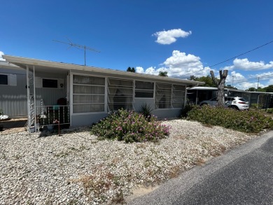 Free boat dock with access to the Dora Canal. The sunroom offers on Bay Tree Golf Course in Florida - for sale on GolfHomes.com, golf home, golf lot