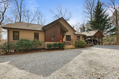 Nestled in a serene, wooded setting, this charming home offers on Sapphire National Golf Club in North Carolina - for sale on GolfHomes.com, golf home, golf lot