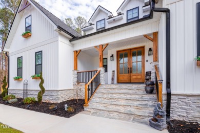 Welcome to this stunning and charming farmhouse-style, perfectly on River Golf and Country Club at Lake Royale in North Carolina - for sale on GolfHomes.com, golf home, golf lot