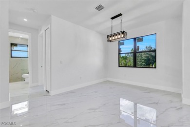 Experience modern luxury and family-friendly living in this on Lehigh Resort Club in Florida - for sale on GolfHomes.com, golf home, golf lot