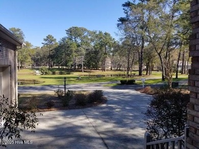 This beautiful home, across from a pretty pond, is located along on Lockwood Folly Country Club in North Carolina - for sale on GolfHomes.com, golf home, golf lot