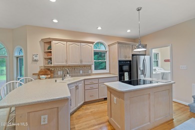 This beautiful home, across from a pretty pond, is located along on Lockwood Folly Country Club in North Carolina - for sale on GolfHomes.com, golf home, golf lot