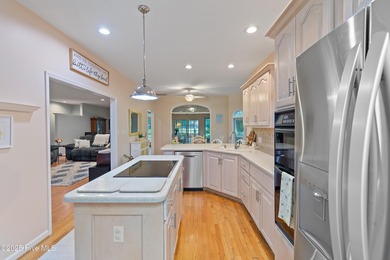 This beautiful home, across from a pretty pond, is located along on Lockwood Folly Country Club in North Carolina - for sale on GolfHomes.com, golf home, golf lot