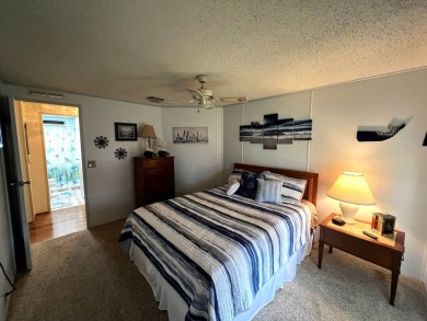 This delightful 2-bedroom, 2-bathroom retreat boasts a generous on Lake Henry Golf Club in Florida - for sale on GolfHomes.com, golf home, golf lot