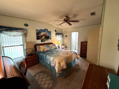 This delightful 2-bedroom, 2-bathroom retreat boasts a generous on Lake Henry Golf Club in Florida - for sale on GolfHomes.com, golf home, golf lot