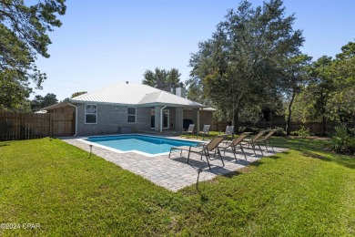 Nestled on an oversized lot, this single-level brick home in on Santa Rosa Golf and Beach Club in Florida - for sale on GolfHomes.com, golf home, golf lot