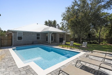 Nestled on an oversized lot, this single-level brick home in on Santa Rosa Golf and Beach Club in Florida - for sale on GolfHomes.com, golf home, golf lot