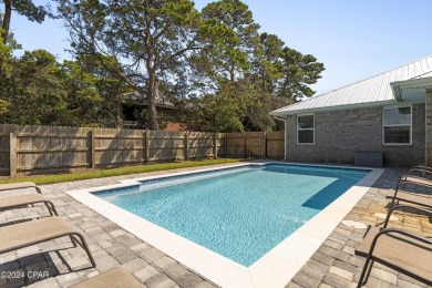 Nestled on an oversized lot, this single-level brick home in on Santa Rosa Golf and Beach Club in Florida - for sale on GolfHomes.com, golf home, golf lot