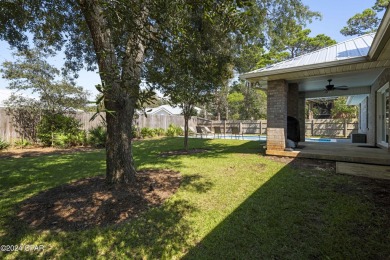 Nestled on an oversized lot, this single-level brick home in on Santa Rosa Golf and Beach Club in Florida - for sale on GolfHomes.com, golf home, golf lot