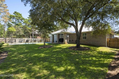 Nestled on an oversized lot, this single-level brick home in on Santa Rosa Golf and Beach Club in Florida - for sale on GolfHomes.com, golf home, golf lot