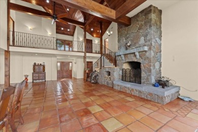 Passing through a custom lava rock gated entry to the impressive on Fall River Valley Golf and Country Club in California - for sale on GolfHomes.com, golf home, golf lot