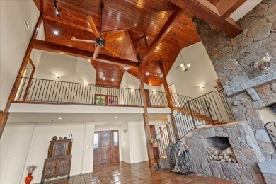 Passing through a custom lava rock gated entry to the impressive on Fall River Valley Golf and Country Club in California - for sale on GolfHomes.com, golf home, golf lot