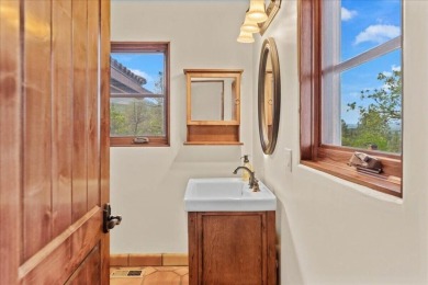 Passing through a custom lava rock gated entry to the impressive on Fall River Valley Golf and Country Club in California - for sale on GolfHomes.com, golf home, golf lot