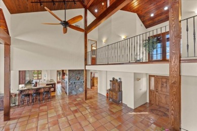 Passing through a custom lava rock gated entry to the impressive on Fall River Valley Golf and Country Club in California - for sale on GolfHomes.com, golf home, golf lot