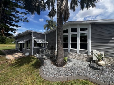 This beautifully updated 2-bedroom, 2-bathroom unfurnished home on Lake Henry Golf Club in Florida - for sale on GolfHomes.com, golf home, golf lot