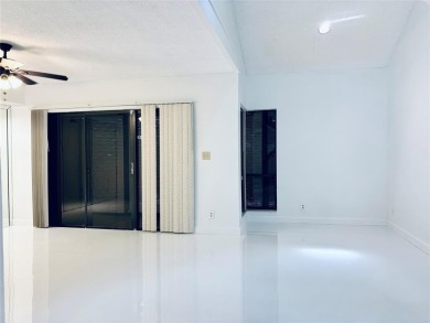 Lovely townhome. It features fresh paint, new porcelain tile on on Woodmont Country Club in Florida - for sale on GolfHomes.com, golf home, golf lot