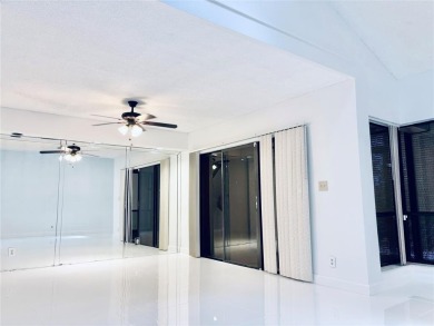 Lovely townhome. It features fresh paint, new porcelain tile on on Woodmont Country Club in Florida - for sale on GolfHomes.com, golf home, golf lot