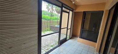 Lovely townhome. It features fresh paint, new porcelain tile on on Woodmont Country Club in Florida - for sale on GolfHomes.com, golf home, golf lot