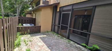 Lovely townhome. It features fresh paint, new porcelain tile on on Woodmont Country Club in Florida - for sale on GolfHomes.com, golf home, golf lot