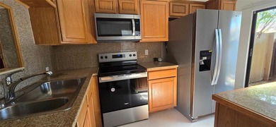 Lovely townhome. It features fresh paint, new porcelain tile on on Woodmont Country Club in Florida - for sale on GolfHomes.com, golf home, golf lot