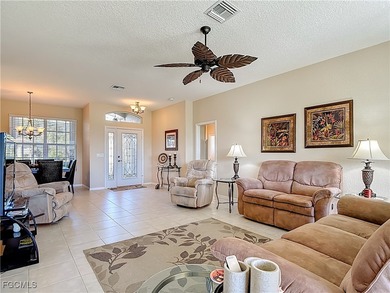 This beautifully maintained LAKEFRONT Sandpiper model home in on Herons Glen Golf and Country Club in Florida - for sale on GolfHomes.com, golf home, golf lot