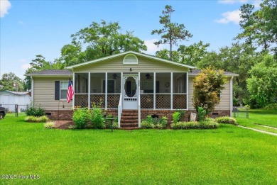 This sweet coastal cottage is move in ready. Sit on the screened on Sea Trail Golf Resort in North Carolina - for sale on GolfHomes.com, golf home, golf lot