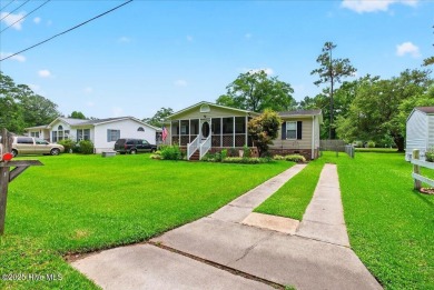 This sweet coastal cottage is move in ready. Sit on the screened on Sea Trail Golf Resort in North Carolina - for sale on GolfHomes.com, golf home, golf lot
