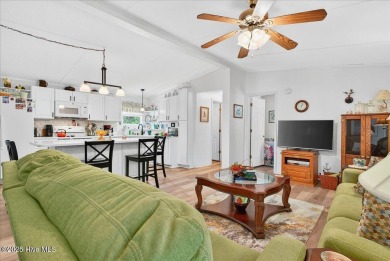 This sweet coastal cottage is move in ready. Sit on the screened on Sea Trail Golf Resort in North Carolina - for sale on GolfHomes.com, golf home, golf lot