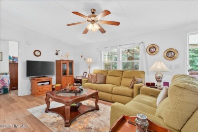 This sweet coastal cottage is move in ready. Sit on the screened on Sea Trail Golf Resort in North Carolina - for sale on GolfHomes.com, golf home, golf lot