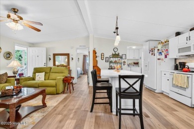 This sweet coastal cottage is move in ready. Sit on the screened on Sea Trail Golf Resort in North Carolina - for sale on GolfHomes.com, golf home, golf lot